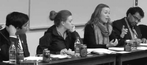 Gillian Wilson, NAITSA VP Student Services, speaks to the student Senate during its Dec. 10 meeting. Looking on are President Hasib Baig, left, VP Academic Rechelle Eklund and VP External Justin Nand. 