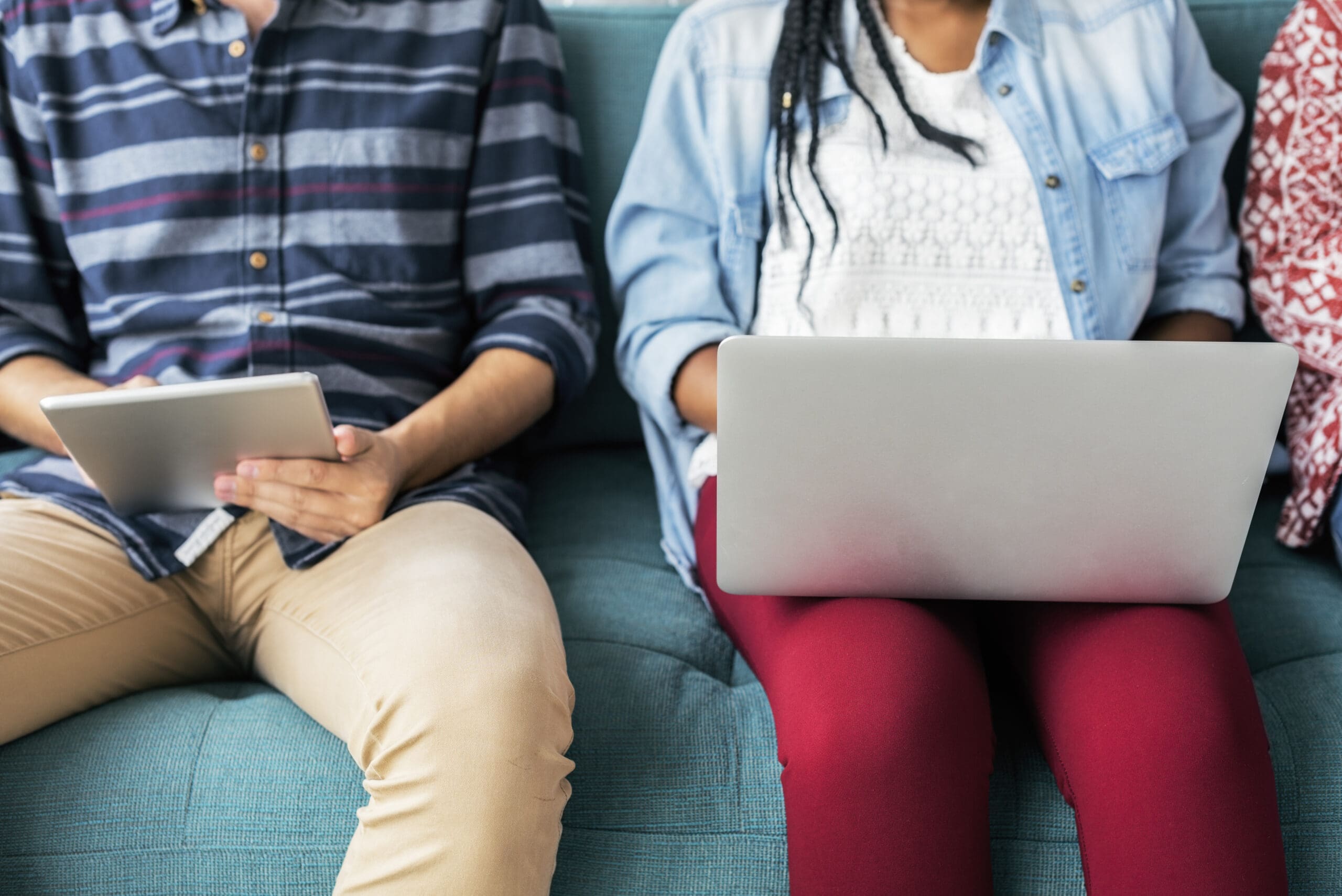 students sitting on couch and working together