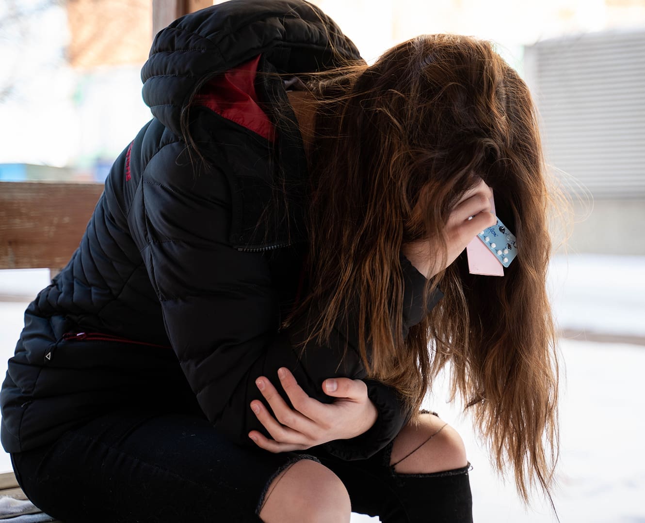 Why hormonal birth control is unhealthy for you Upset girl holding birth control