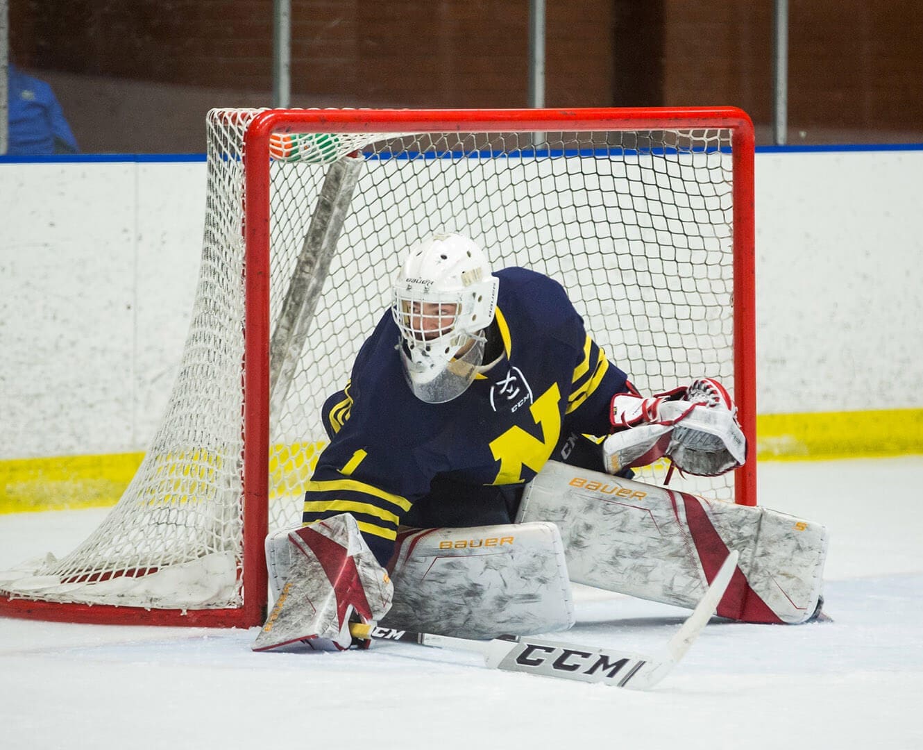 NAIT Ooks goalie fresh from WHL Goalie stops a shot in the net during hockey game
