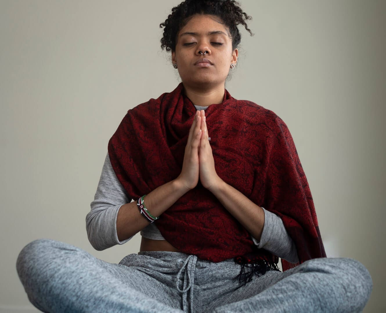 Meditate with a Monk at NAIT’s Student Association Image of woman sitting cross legged with palms together meditating