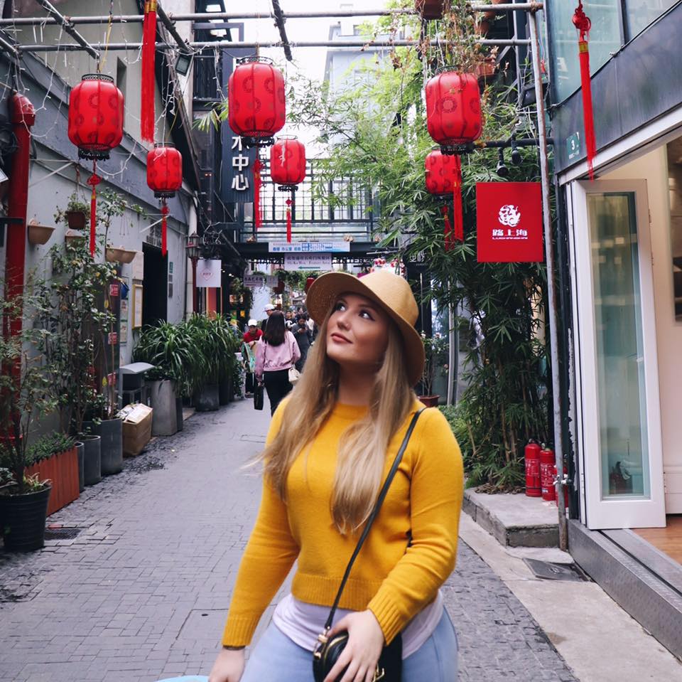 Woman walks down busy street in Shanghai