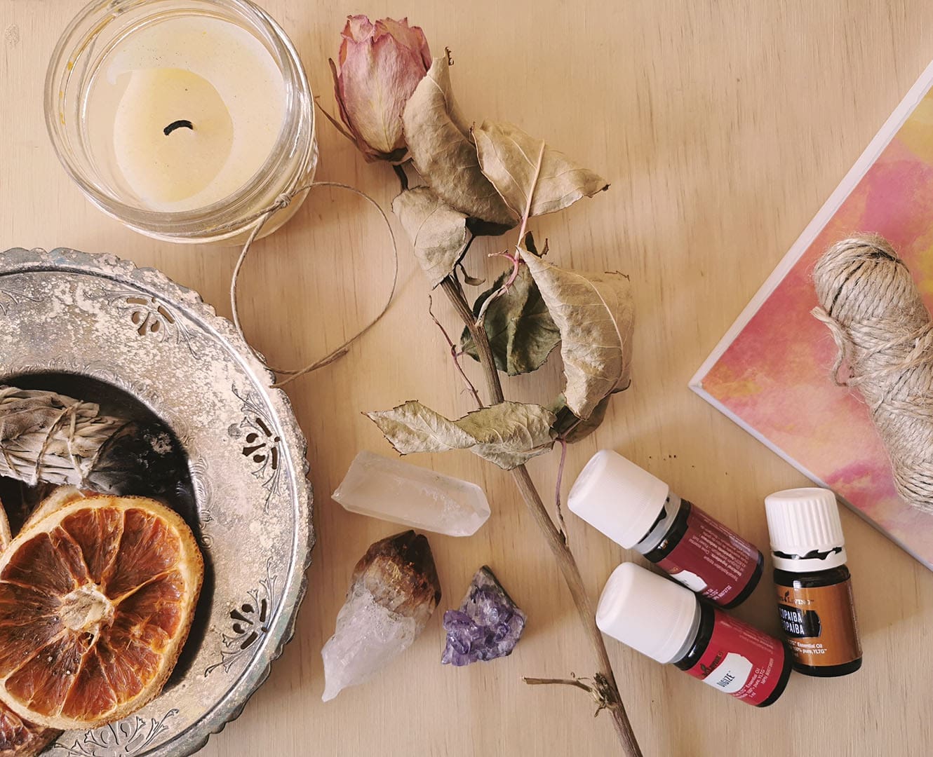 Dried rose, essential oils notebook sage and crystals