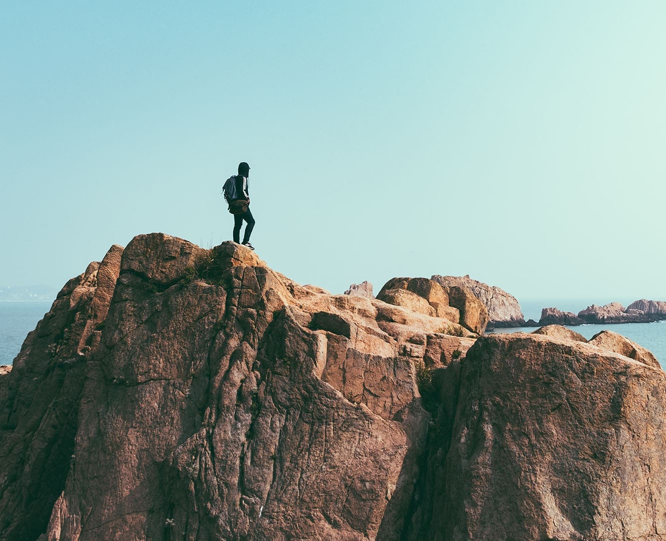 Man standing on top of mountain peak
