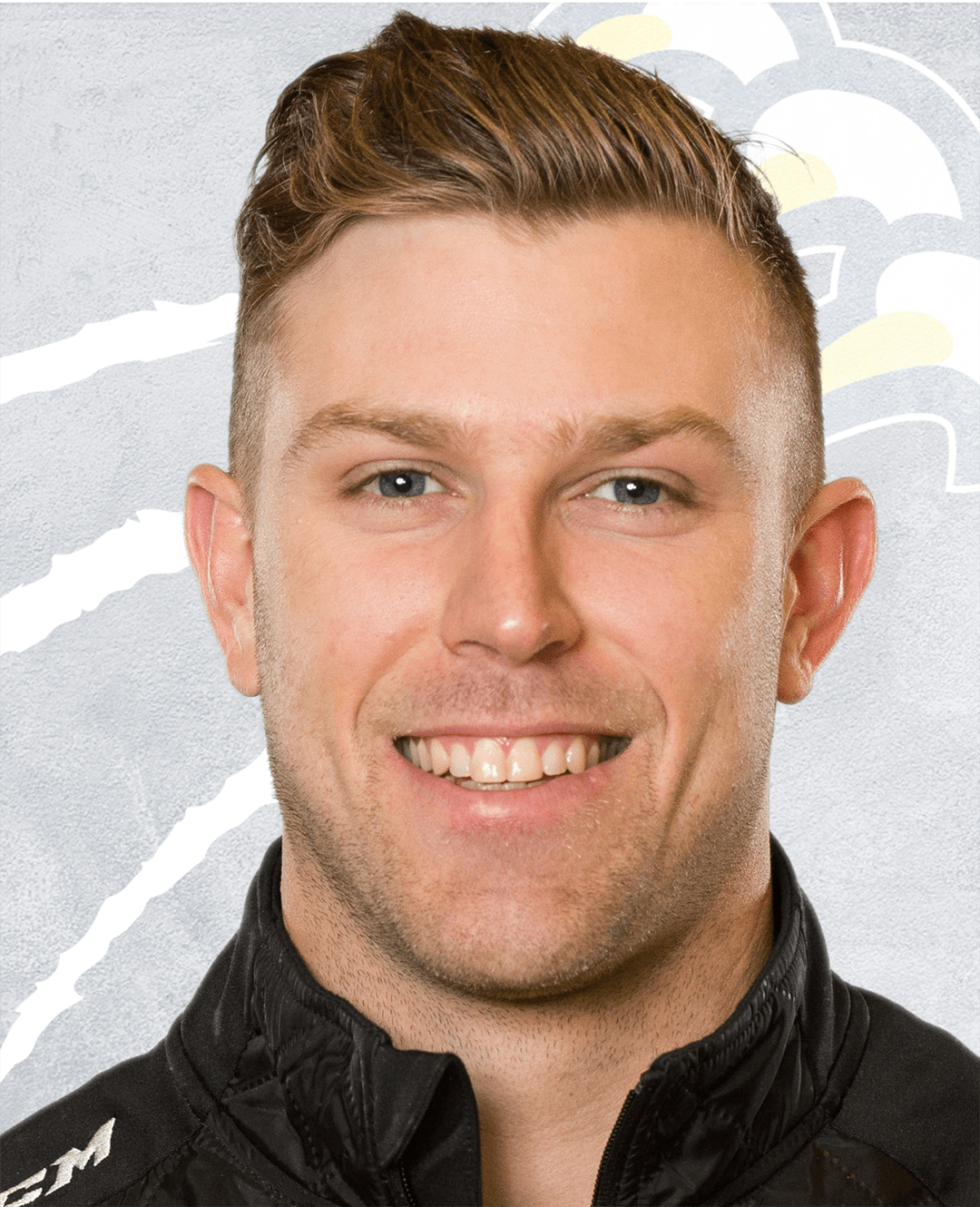 Scott Fellnermayr stands facing the camera smiling