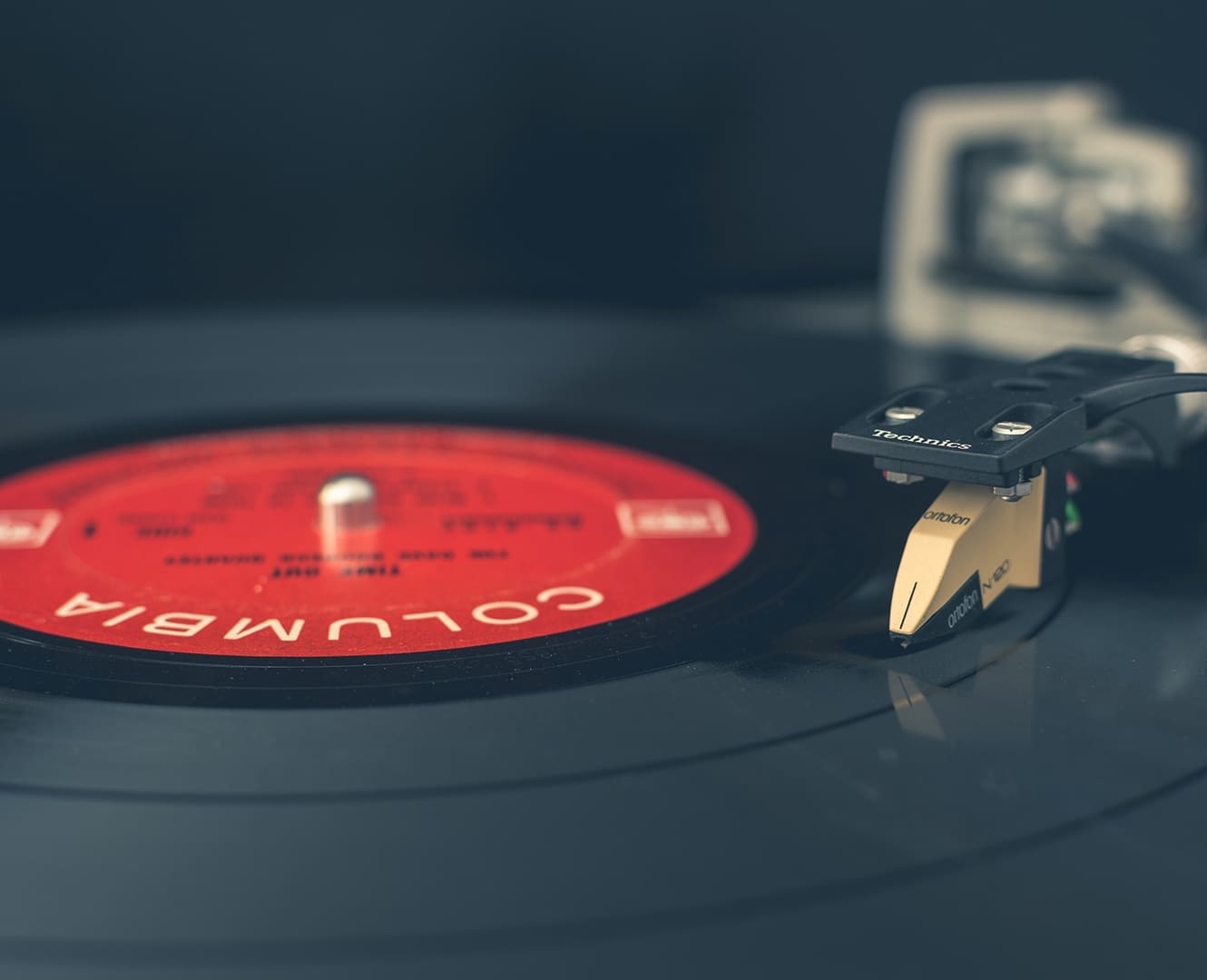 Record player with a record and the needle of the record player