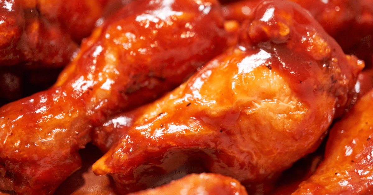 a photo of chicken wings covered in a spicy sauce