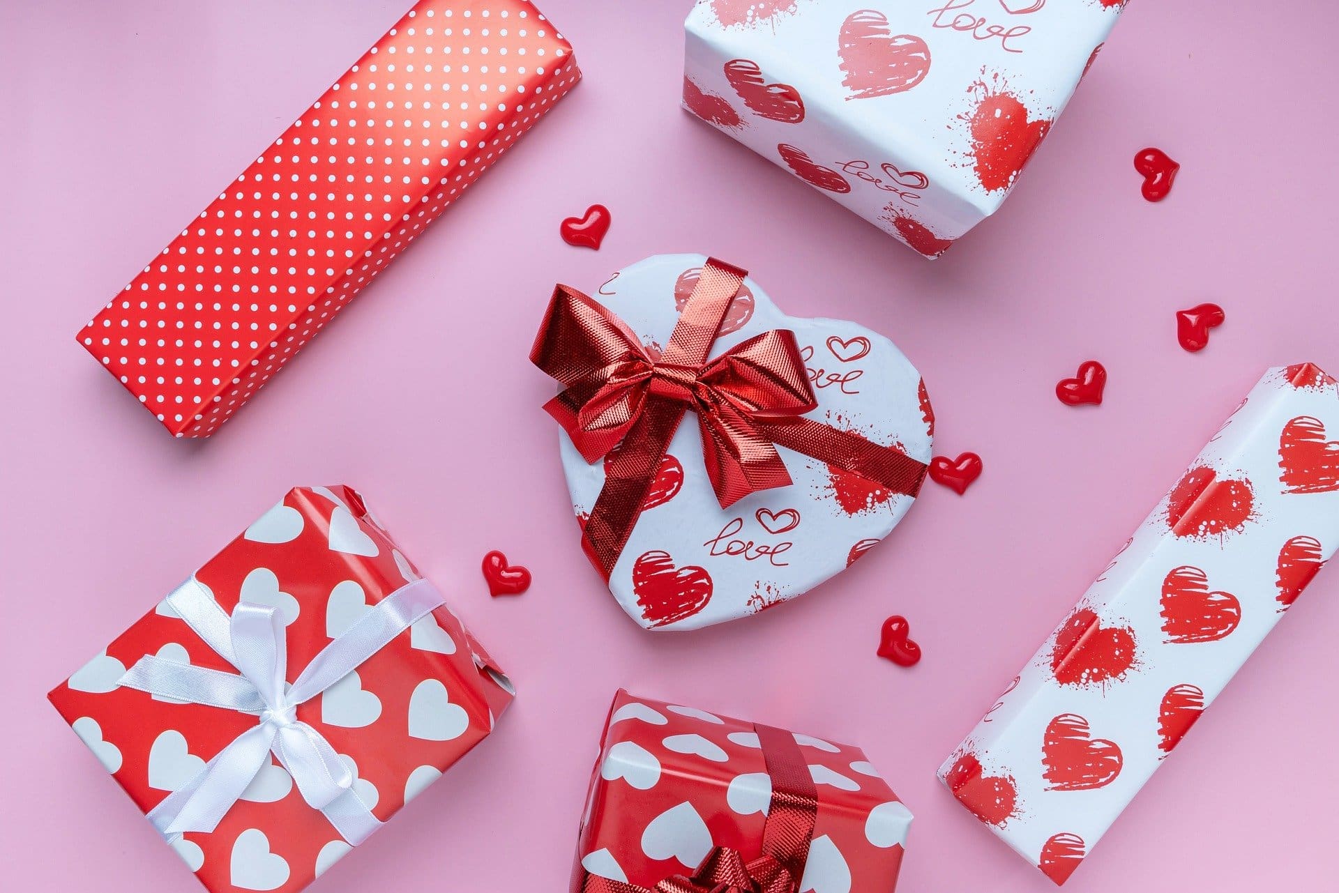 red and white heart-print boxes on a pink background