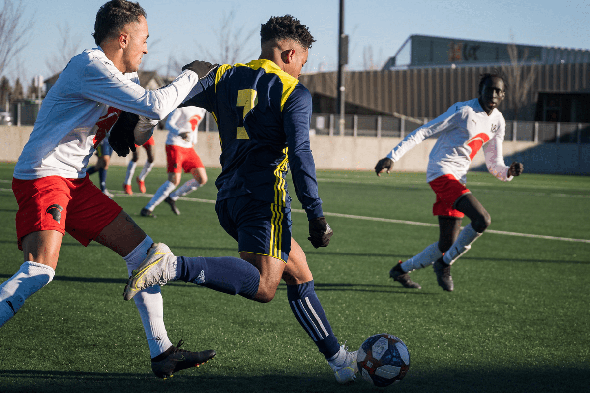 Ooks Soccer College soccer players kicking the ball