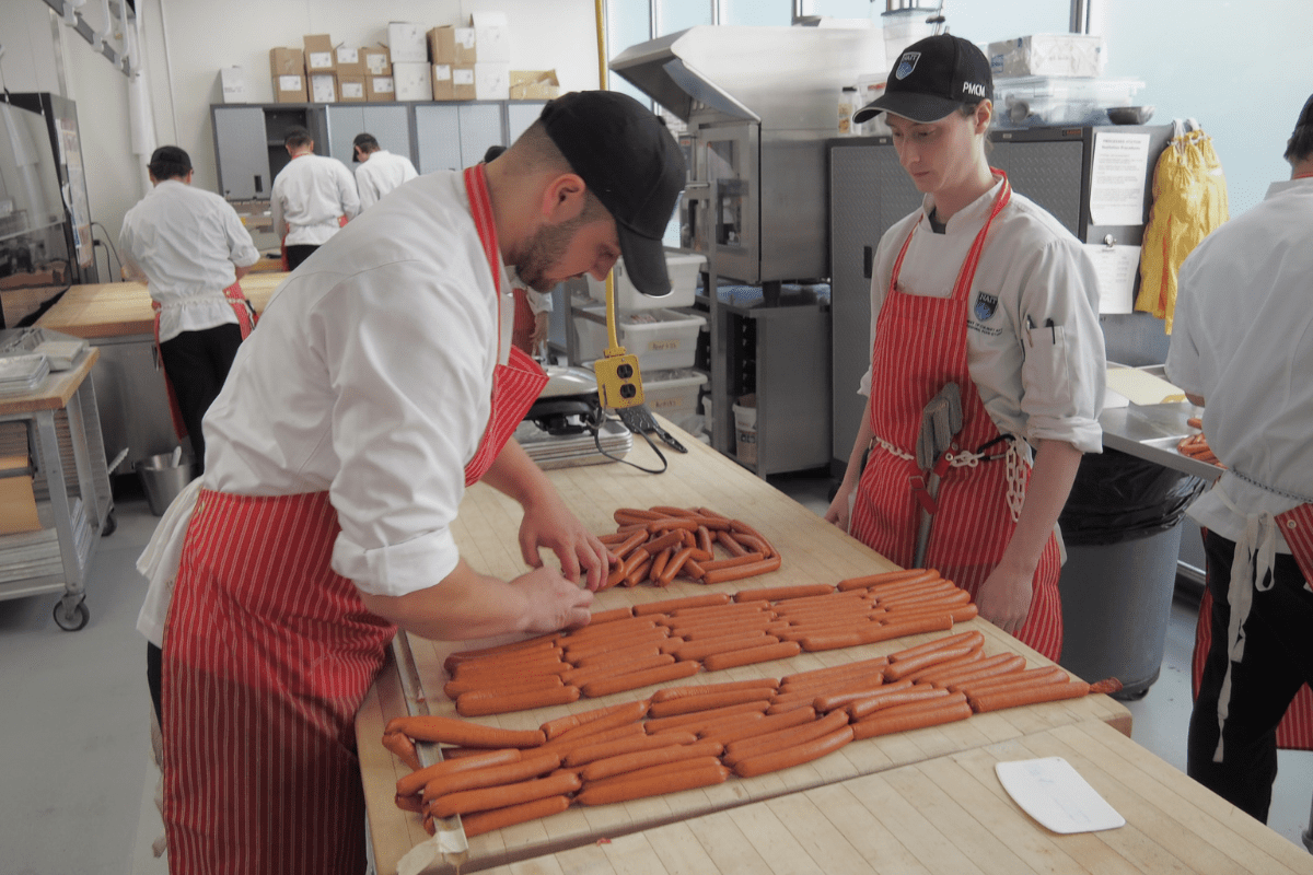students working in the retail meat store