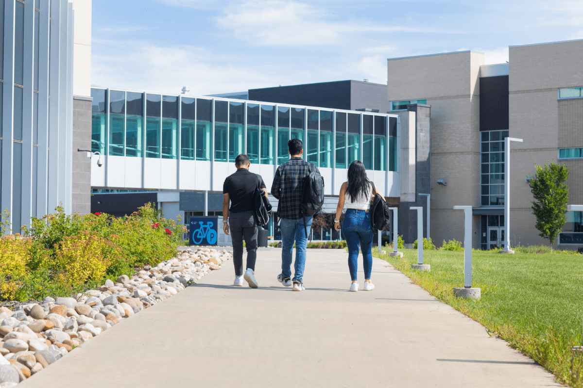 three students walk in the distance at CAT quad
