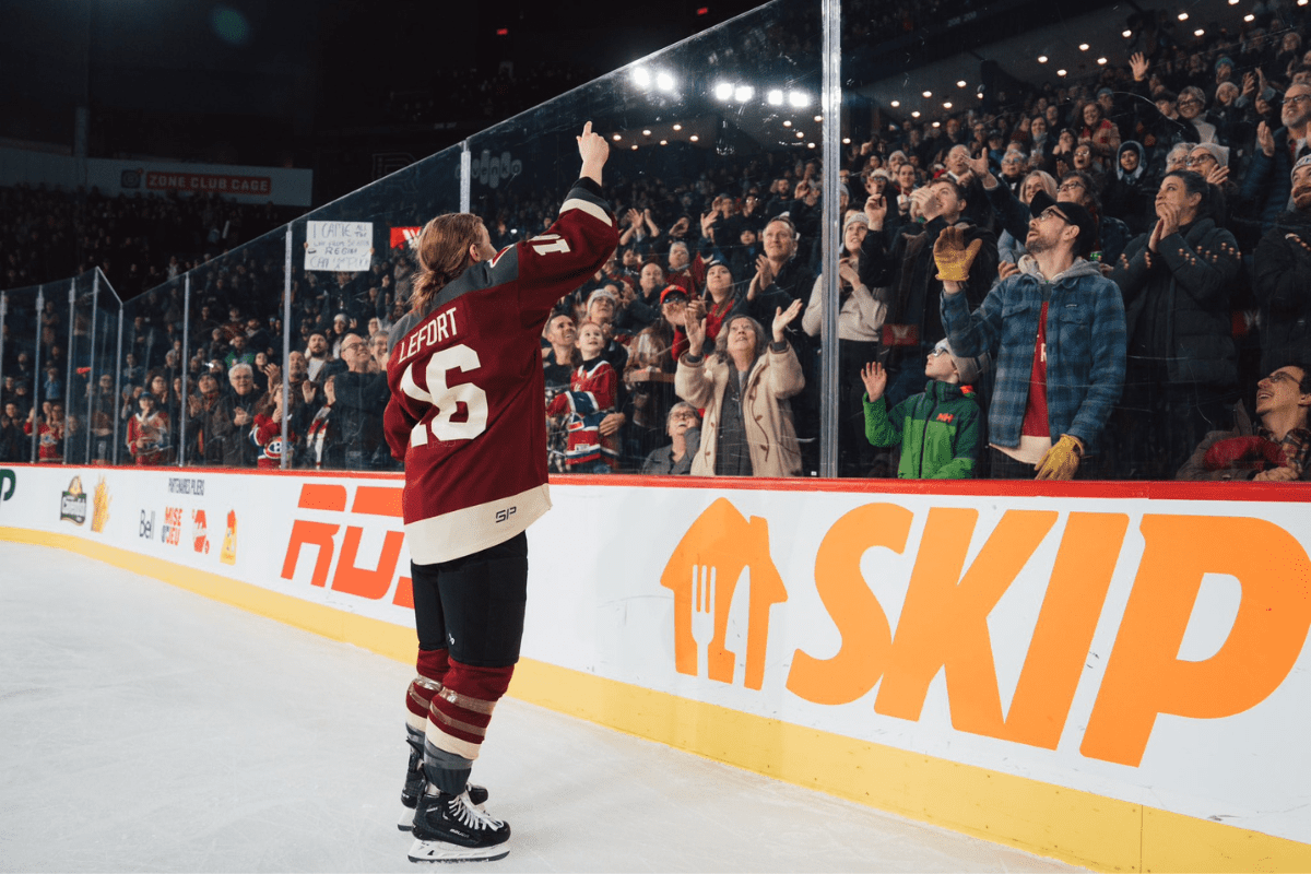 pwhl womens hockey sarah lefort, a member of the montreal team in the pwhl, stands on the ice looking up at stands packed full of smiling fans