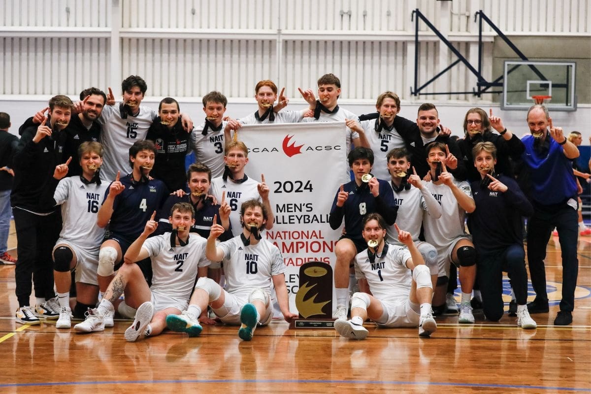 men’s vb championship a group of men wearing jerseys hold up gold medals and pose with a banner in the middle that says 2024 men's volleyball champions