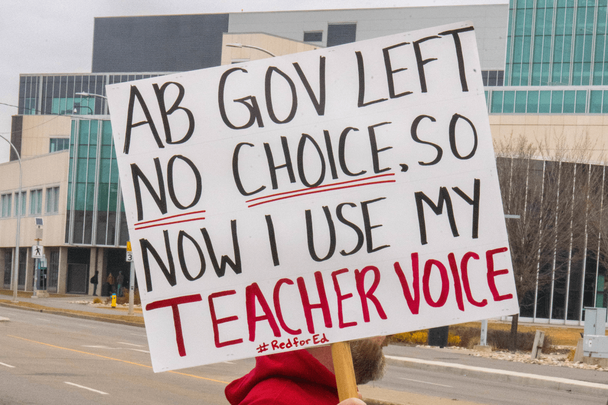 AB government teachers’ strike A protester outside NAIT holds a sign up in support of Alberta teachers on Oct. 30, 2025.