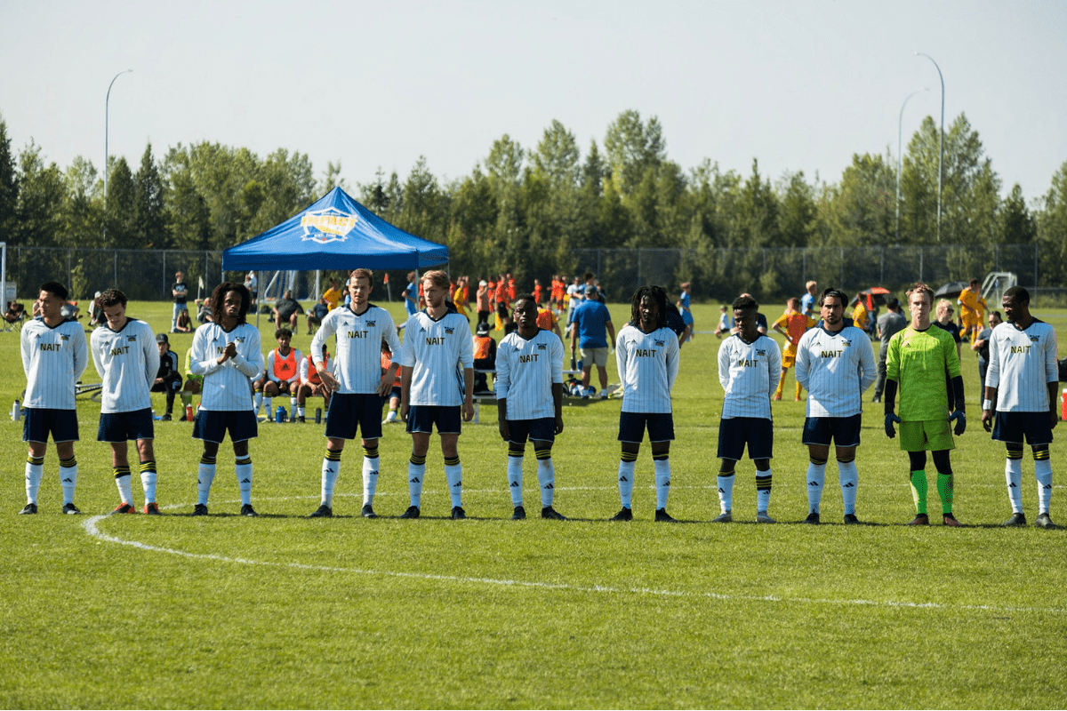 The Ooks men's soccer team stands together during a game.